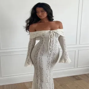 Elegant white lace off-shoulder maxi dress with romantic bell sleeves and bodycon fit