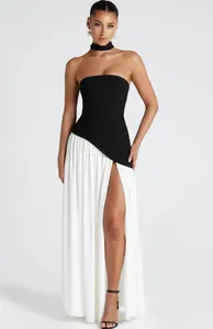 Elegant strapless evening dress with black top, white high slit skirt and choker accessory.