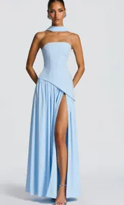 Front view of light blue strapless evening gown with high slit and halter neck scarf