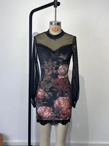 Close-up detail of sheer mesh sleeves and delicate lace trim on floral print mini dress