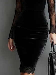 Close-up of black velvet bodycon dress featuring elegant lace sleeves and hem detailing
