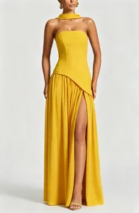 Elegant detailed view of yellow strapless maxi dress with high thigh slit and neck scarf