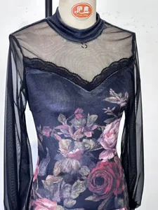 Detail view of the floral print and delicate lace trim on a mesh spliced dress