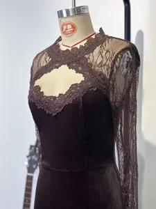 Close-up showing the intricate lace sleeves and chest cutout on a dark velvet dress