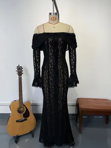 Full-length view of an elegant black lace off-the-shoulder evening gown with bell sleeves.