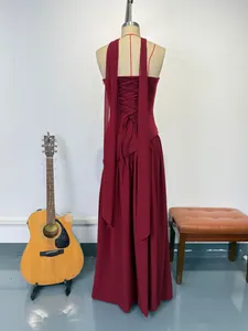 Back view detail of a burgundy halter formal gown featuring a lace-up ribbon design
