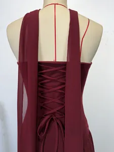 Close-up of the elegant lace-up back and chiffon streamers on a wine red dress.