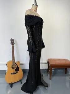 Elegant black lace off-the-shoulder evening gown with flare sleeves on mannequin