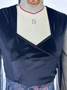 Close-up showing the mesh sleeve patchwork and wrap-style bust of black velvet dress
