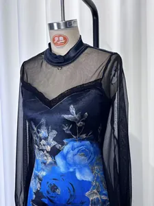 Close-up of navy blue dress with mesh splicing and vibrant floral print design