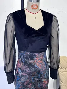 Detail view of black sheer mesh sleeves on an elegant floral print bodycon dress