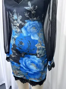 Detailed view of floral print velvet dress featuring mesh sleeves and delicate lace trim
