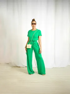 Stylish green two-piece lounge set featuring short sleeve crop top and wide-leg cargo pants