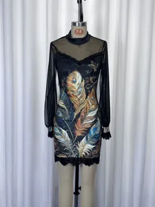 Detail view of mesh mini dress with peacock feather print and lace hem decoration