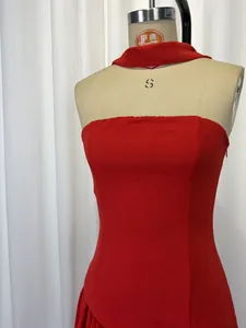 Close-up view of a vibrant red strapless halter neck dress showing design details