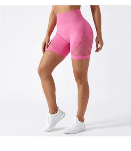 Detail view of women's pink high-waist running shorts with breathable mesh paneling design