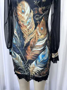 Detailed view of the feather print dress featuring mesh sleeves and delicate lace trim accents.