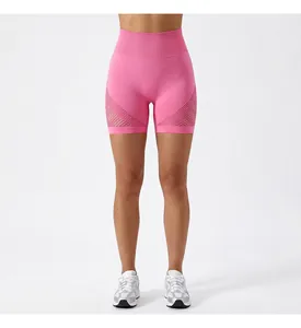 Close-up view of pink high-waisted yoga shorts featuring breathable mesh side details