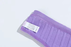 Close-up of purple ribbed cotton thong showing care label and material composition