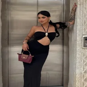Robe longue sexy noire à licou avec découpe à la taille pour un look d'été chic.