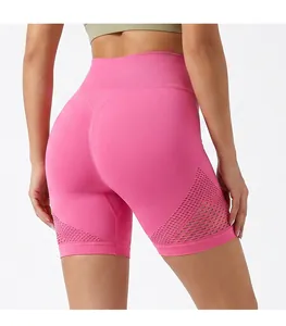 Detailed macro view of pink high-waisted yoga shorts with breathable side mesh panels.