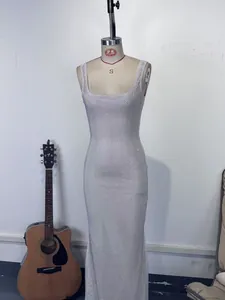 Vue complète d'une robe de soirée étincelante à paillettes argentées sur un mannequin.