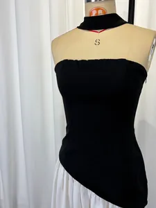 Detail of a sexy black strapless halter neck dress with asymmetrical white skirt