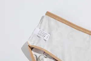 Close-up of washing tag on milk silk women's panties showing material and size info