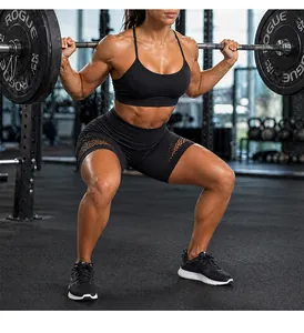 Detail of high-waisted black yoga shorts with breathable mesh panels for gym training.