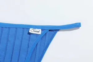 Detailed macro view showing the soft ribbed texture and 'Sweet' tag on blue cotton thong