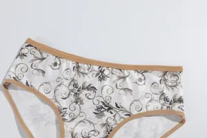 Close-up of milk silk floral print panties featuring a comfortable brown elastic trim