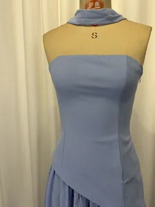 Detail view of light blue strapless formal dress with matching neck scarf on mannequin