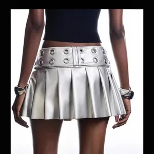 Close-up of silver metallic pleated mini skirt with punk style eyelet belt details.