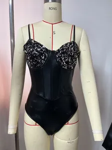 Detailed view of black faux leather bodysuit with sequined bust and corset boning features