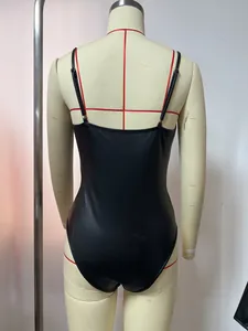 Back view of a black faux-leather bodysuit displayed on a professional mannequin