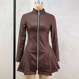 Detailed view of a brown faux leather dress featuring a pleated skirt and front zip.