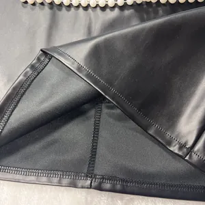 Close-up detail of high-quality stitching and fabric lining on a black PU leather skirt