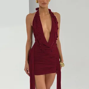 Close-up of wine red halter mini dress with deep V-neck and teardrop bead accents