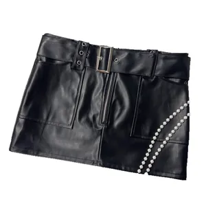 Chic Y2K black PU leather mini skirt with decorative pearl chain and metal belt buckle