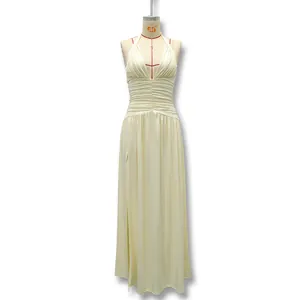 Full front detail of a cream halter-neck evening gown featuring a ruched bodice and slit