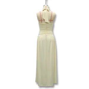 Back view of elegant cream halter-neck backless evening gown on mannequin