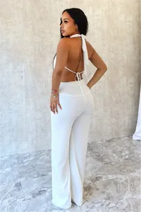 Vue arrière d'un ensemble sexy haut dos nu blanc et pantalon large assorti pour femme