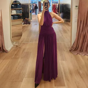 Side view detail of an elegant purple halter backless maxi dress featuring a sexy high leg slit