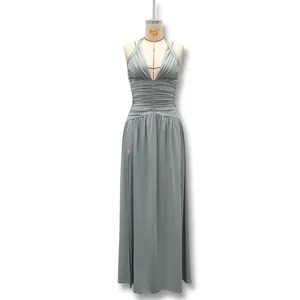 Full length view of elegant gray halter neck evening dress with ruching and high slit details.