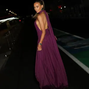 Elegant halter-neck backless purple maxi dress featuring a flowing pleated night gown skirt.