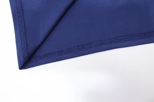 Close-up detail of the neat overlock stitching on the navy blue evening dress hemline