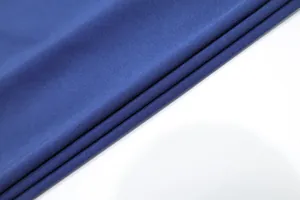 Close-up detail of high-quality navy blue stretch fabric for elegant evening dress