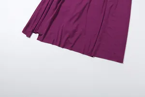 Close-up of the elegant purple dress hem featuring a side slit design for a sophisticated look.