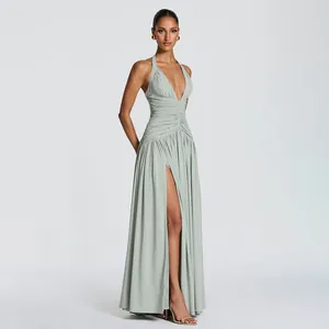 Full view of elegant sage green halter neck evening gown with high leg slit detail