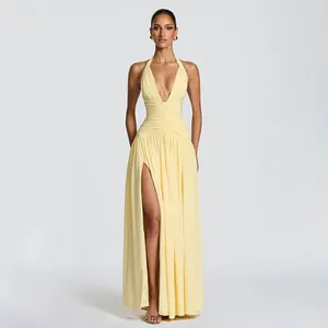 Elegant light yellow halter neck evening dress with high slit and ruched waist detail.